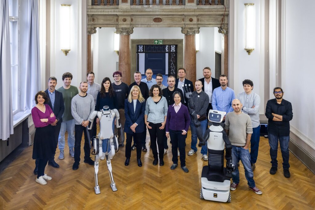 Project team picture with two robots in the front